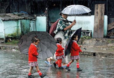 mother and daughters in rain