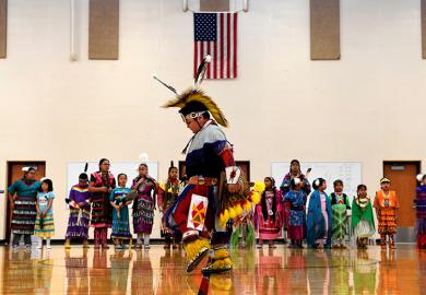 A student performs a traditional style dance in full regalia at the 21st Century Community Learning Center, USA. Students that are part of the after school learning program learn the Arapaho language, culture, history and traditions of the Arapaho tribe.