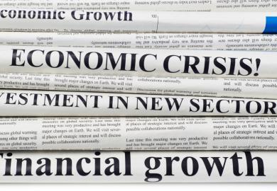 Newspaper front pages with economics headlines