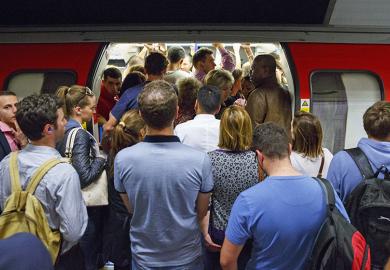 Commuters queuing for tube trains at Green Park Tube Station in evening rush hour in London, England. To illustrate that universities are churning out PhD graduates that have little prospect of securing an academic job.