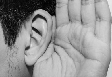 Person cupping hand to ear