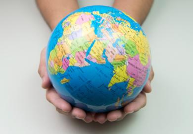 Person holding world in hands (university rankings)