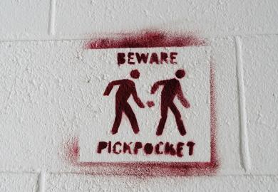 Pickpocket warning sign stencilled on to a white wall to. illustrate I’m being docked pay for boycotting marking – but I teach for free!