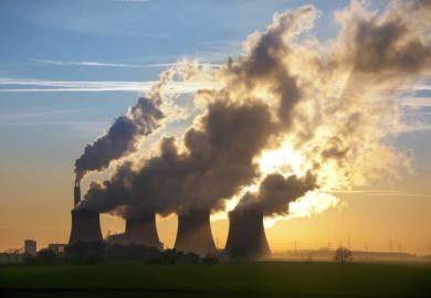 Smoke from power station chimneys, illustrating the environmental impact of AI