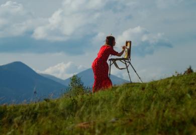 A woman paints on a mountain slope, illustrating practice research