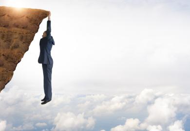 A man hangs from a precipice
