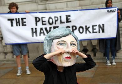 Protester in Theresa May mask