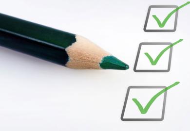A green pencil beside ticked boxes
