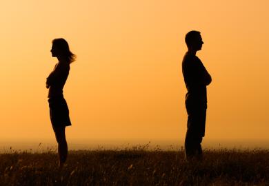 Two people in silhouette looking away from each other