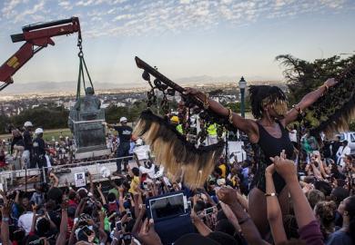 Students cheer as the Cecil Rhodes statue is being removed from the University of Cape Town on April 9, 2015
