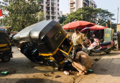 A rickshaw wheel is repaired