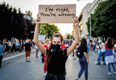 woman holding protest placard 