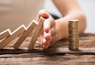dominoes falling onto a pile of coins