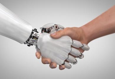 A robot hand shakes a human hand
