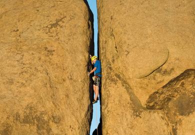 Rock climbing narrow crevice