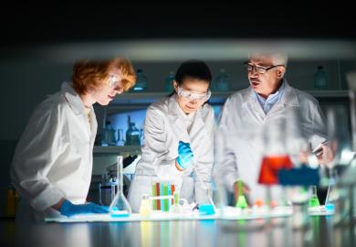 Scientists with liquids of various colours in test tubes, symbolising policy options