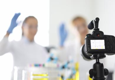 A camera films a scientist, symbolising science communication
