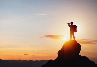 A man looks through binoculars, symbolising internet searching