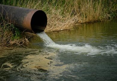 A pipe drains sewage into a river