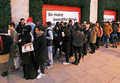 Shoppers queue outside Selfridges department store, London