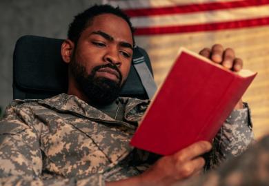 A soldier reading a book