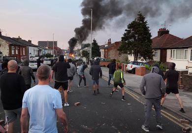 Protesters throw stones at police after disorder broke out on July 30, 2024 in Southport, England. Rumours about the identity of the 17-year-old suspect in yesterday's deadly stabbing attack here have sparked a violent protest.