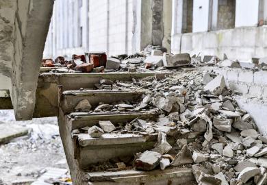 A shattered staircase covered in debris