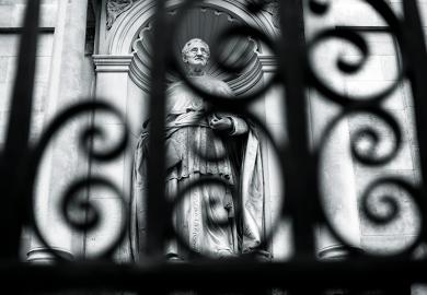 Statue behind a fence