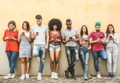 A group of students using mobile phones, symbolising student technology councils 