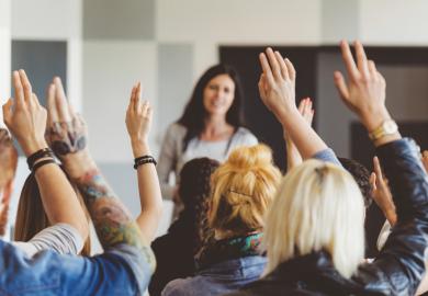 Students raising hands during lecture
