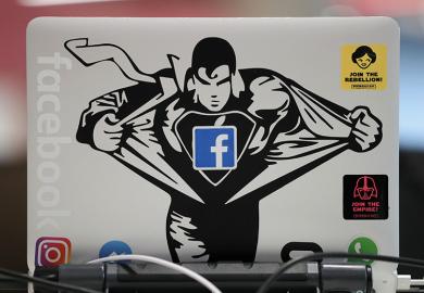 Superman sticker on Macbook computer