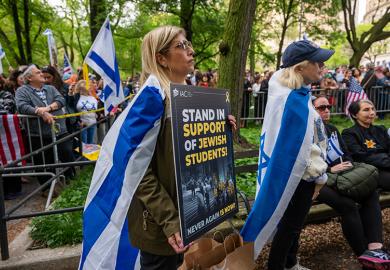 People attend a Holocaust memorial ceremony held a block away from Columbia University as protests both for and against Israel continue at area universities and colleges on 6 May, 2024 in New York City. 