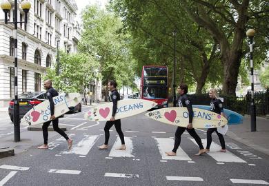 Surfers cross the road