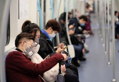 People on subway wearing surgical masks