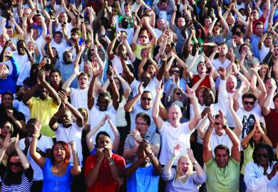 Crowd of people clapping and cheering