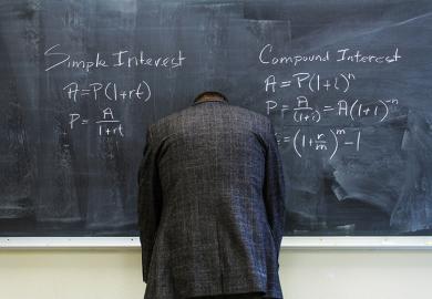 A teacher turned to face the blackboard