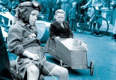 Young competitors make their way to the starting point on an assortment of vehicles.