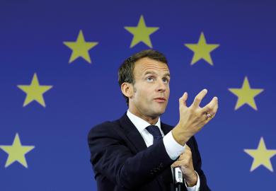 Image of Emmanuel Macron in front of EU flag