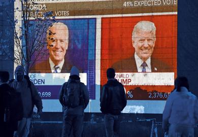 People watch a big screen displaying the live election results in Florida at Black Lives Matter plaza across from the White House on election day in Washington, DC on November 3, 2020.