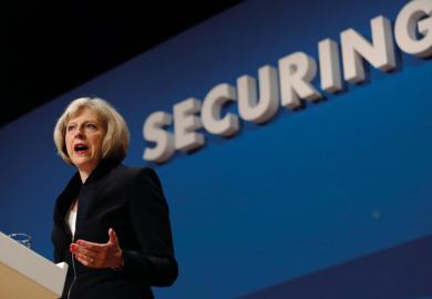 Theresa May speaking at podium