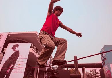 man walking on tightrope