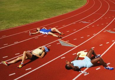 Tired runner lie on the track, illustrating a lack of resilience