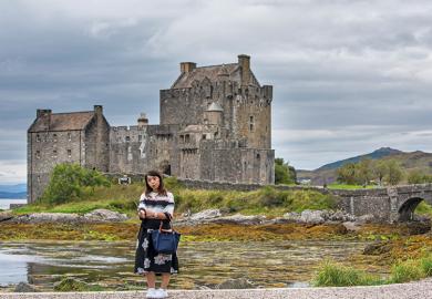 Tourist taking selfie at Eilean Donan Castle