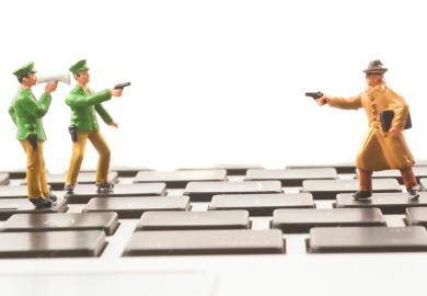 Toy cops and robber on keyboard
