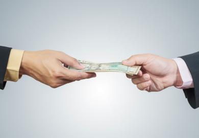 Two hands exchanging money