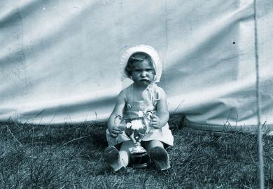 Unhappy child holding a winners cup to illustrate Teaching awards are  for losers, not winners
