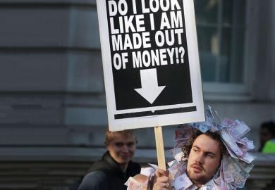 Student holds a placard dressed in bank notes to illustrate Conflict on many fronts
