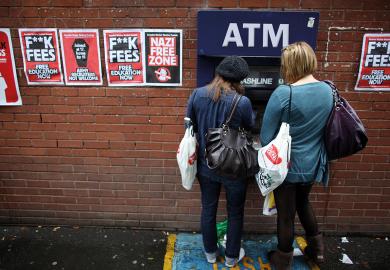 Students arriving for Manchester University's freshers week queue up at a cash machine in Manchester, England. 