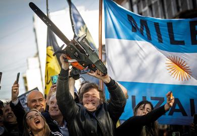Presidential candidate Javier Milei of La Libertad Avanza lifts a chainsaw next to Buenos Aires province governor candidate