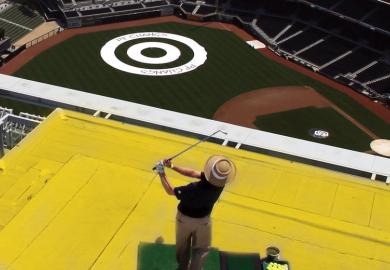 Player hits golf ball off a roof attempting to land the ball on a balls-eye planted in a field as a metaphor for Now is the time to take action on the UK’s R&D spending target